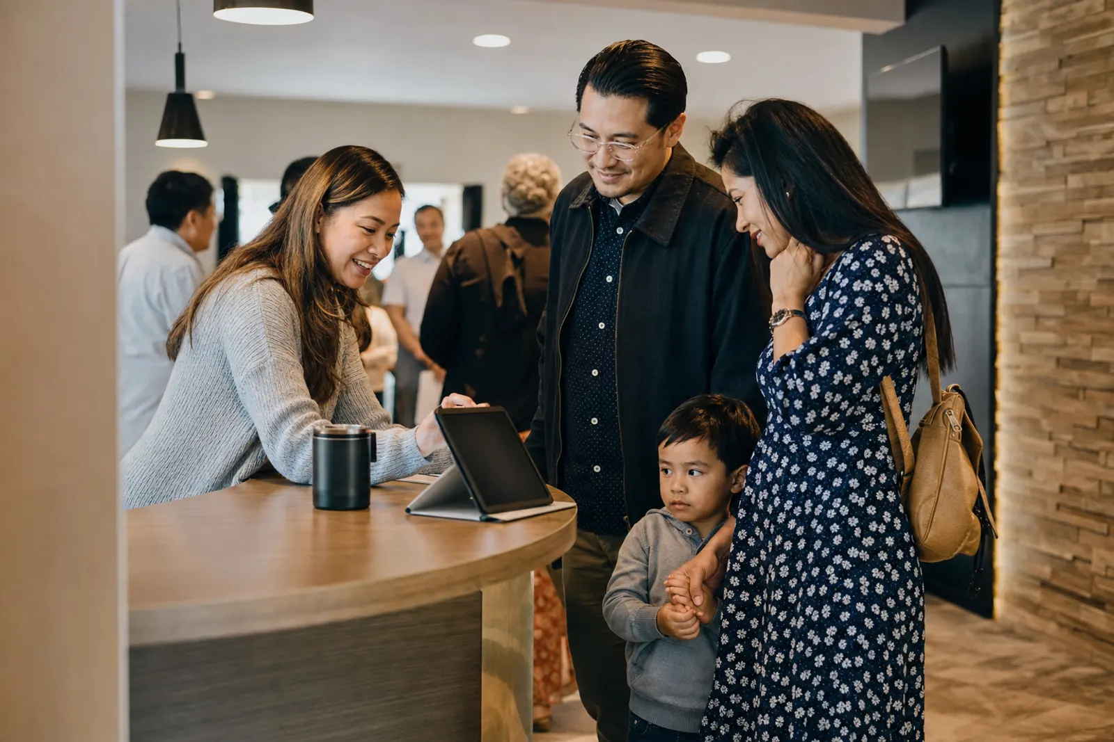 A greeter helps a new family at the welcome desk.