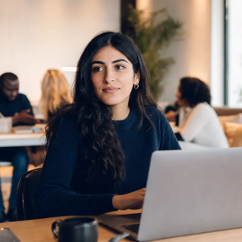 A communications lead at a laptop.