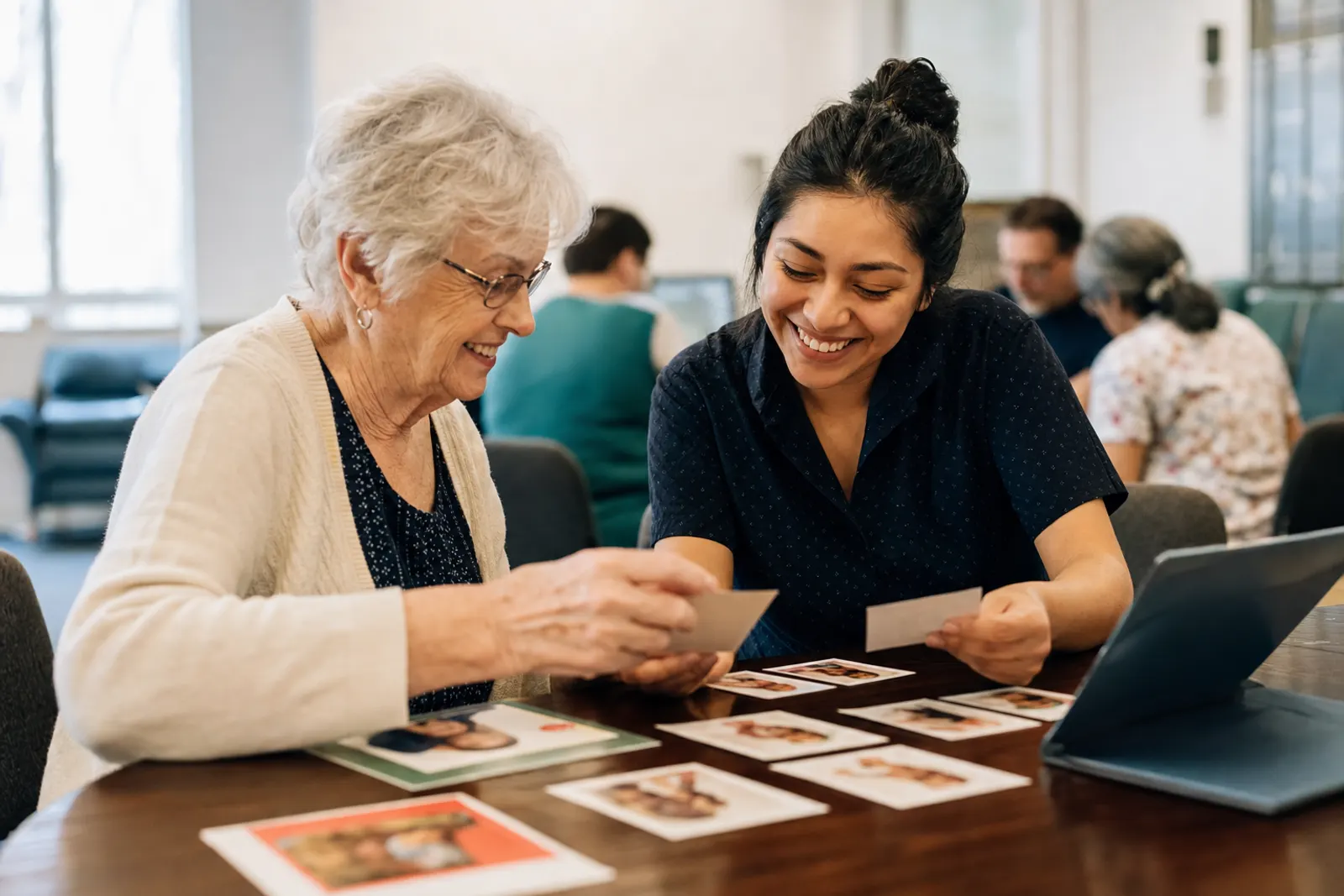 A volunteer and a staff member match family cards against the record.