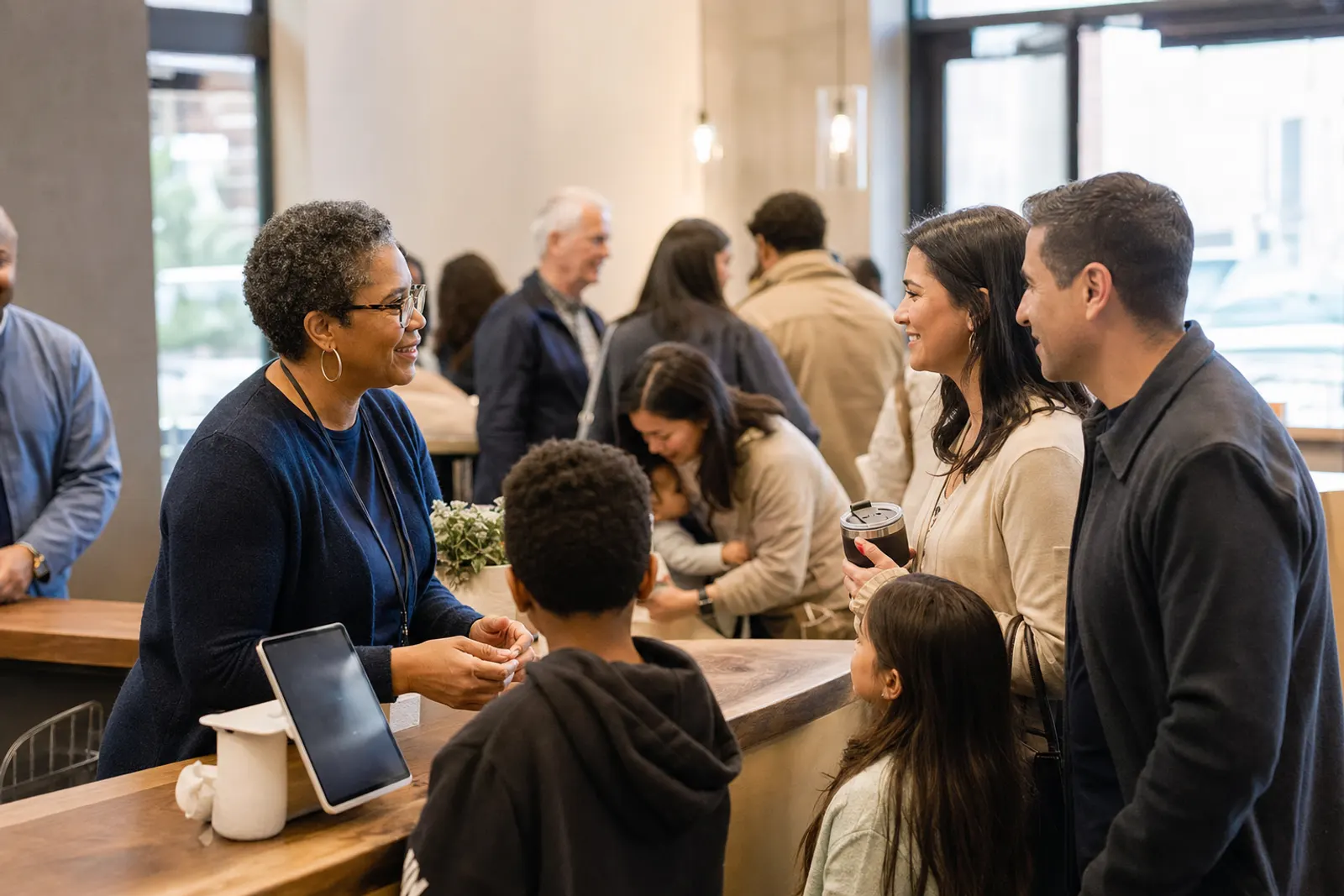 A volunteer welcomes a family at Sunday check-in.