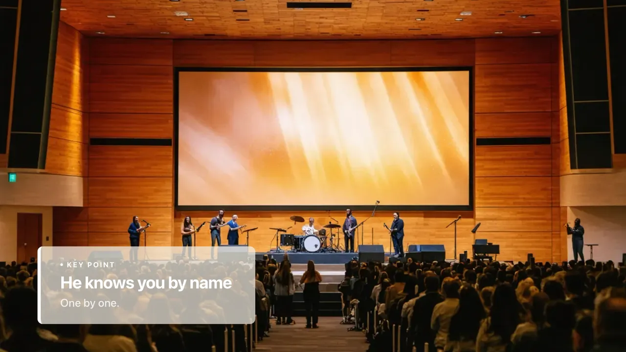 A broadcast lower third reading He knows you by name over the congregation in worship.